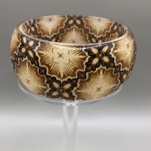 Vintage earthy neutral colors pattern fabric inlay lucite bangle bracelet.